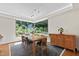 Bright dining room featuring a large window with a view of the lush backyard at 105 Juniper Ct, Carrboro, NC 27510