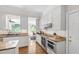 Well-appointed kitchen featuring white cabinetry, granite counters, and stainless steel appliances at 105 Juniper Ct, Carrboro, NC 27510