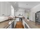 Bright kitchen featuring white cabinets, granite countertops, stainless steel appliances, and hardwood floors at 105 Juniper Ct, Carrboro, NC 27510