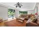 Inviting living room with expansive windows that showcase a beautifully landscaped outdoor space at 105 Juniper Ct, Carrboro, NC 27510