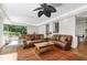 Open concept living room with large windows and a comfortable leather sofa at 105 Juniper Ct, Carrboro, NC 27510