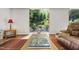Cozy living room with a view to the landscaped backyard and comfortable seating at 105 Juniper Ct, Carrboro, NC 27510