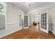 Bright living room with hardwood floors and french doors leading to a connected room at 105 Juniper Ct, Carrboro, NC 27510