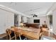 Open-concept living area featuring hardwood floors, a dining table, and a comfortable leather sofa at 105 Juniper Ct, Carrboro, NC 27510