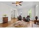 Inviting living room with hardwood floors, neutral walls, and comfortable leather chairs at 105 Juniper Ct, Carrboro, NC 27510