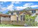 Home backyard featuring a wood fence, patio, and verdant greenery under a bright, partly cloudy sky at 11035 Southwalk Ln, Raleigh, NC 27614