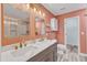 Chic bathroom featuring double vanity, quartz countertop, gold fixtures, and a glass-enclosed shower at 11035 Southwalk Ln, Raleigh, NC 27614