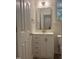 Modern bathroom features a decorative vanity with gold fixtures and rectangular mirror at 11035 Southwalk Ln, Raleigh, NC 27614