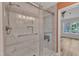 Stylish glass shower features white marble-style tile with a built-in niche and bench at 11035 Southwalk Ln, Raleigh, NC 27614