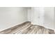 Bedroom featuring neutral walls, wood-look floors, and double closet at 11035 Southwalk Ln, Raleigh, NC 27614