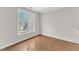 Bright bedroom featuring a large window offering ample natural light and modern brown flooring at 11035 Southwalk Ln, Raleigh, NC 27614