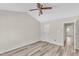 Bright bedroom has neutral walls, wood-look floors, and a ceiling fan at 11035 Southwalk Ln, Raleigh, NC 27614