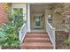 Inviting front porch with brick steps, white railings, and a storm door at 11035 Southwalk Ln, Raleigh, NC 27614