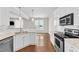 Open kitchen with white cabinets and a granite countertop bar for casual dining at 11035 Southwalk Ln, Raleigh, NC 27614