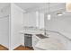 Modern kitchen features white cabinets, granite counters, and stainless steel appliances at 11035 Southwalk Ln, Raleigh, NC 27614