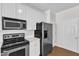 Modern kitchen features stainless steel appliances, ample counter space, and white cabinetry at 11035 Southwalk Ln, Raleigh, NC 27614