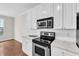 This updated kitchen showcases white cabinets and modern stainless steel appliances at 11035 Southwalk Ln, Raleigh, NC 27614