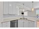 Stylish kitchen features white cabinets, granite counters, and stainless steel appliances at 11035 Southwalk Ln, Raleigh, NC 27614