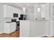 Bright kitchen featuring white cabinets, stainless steel appliances, and a breakfast bar at 11035 Southwalk Ln, Raleigh, NC 27614