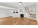 Open living area showcasing a fireplace, staircase, and adjacent kitchen space at 11035 Southwalk Ln, Raleigh, NC 27614