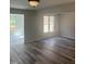 Inviting living room showcases laminate flooring, with views into an adjacent sunroom at 11035 Southwalk Ln, Raleigh, NC 27614
