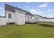 Backyard view with white fenced yard, a detached deck, and a well-maintained lawn at 1104 Cross Creek Dr, Nashville, NC 27856