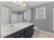 Bathroom featuring double sinks, navy blue cabinets, and modern fixtures at 1104 Cross Creek Dr, Nashville, NC 27856