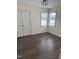 Bedroom featuring two large windows, wood-look flooring, and neutral paint along with a closet at 1104 Cross Creek Dr, Nashville, NC 27856