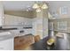 Open concept kitchen with white cabinets, hardwood floors, and stainless steel appliances at 1104 Cross Creek Dr, Nashville, NC 27856