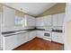 Bright kitchen with white cabinets, stainless steel appliances, and hardwood floors at 1104 Cross Creek Dr, Nashville, NC 27856
