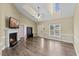 Spacious living room with a vaulted ceiling, fireplace, wood floors and bright natural light at 1104 Cross Creek Dr, Nashville, NC 27856
