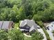 This aerial shot shows a beautiful home surrounded by lush trees, offering privacy and a serene setting at 112 Roseberry Way, Holly Springs, NC 27540
