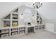 This attic has built in storage and shelves to help stay organized with an attic window for natural light at 112 Roseberry Way, Holly Springs, NC 27540