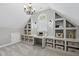 This attic has built in storage and shelves to help stay organized with an attic window for natural light at 112 Roseberry Way, Holly Springs, NC 27540