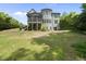 Large backyard with a spacious screened porch and a charming gray house, ideal for outdoor living at 112 Roseberry Way, Holly Springs, NC 27540