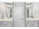Bathroom featuring dual vanities, mirrors, and a connecting door at 112 Roseberry Way, Holly Springs, NC 27540