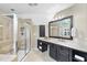 Bathroom with a glass-enclosed shower and vanity with dark cabinets and a bright countertop at 112 Roseberry Way, Holly Springs, NC 27540