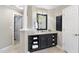 Bathroom vanity with dark cabinets and a bright countertop with a large mirror above it at 112 Roseberry Way, Holly Springs, NC 27540