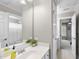 Bathroom featuring a mirror, vanity, shower with curtain and a doorway to the bedroom at 112 Roseberry Way, Holly Springs, NC 27540