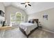 Bedroom featuring a bed, a desk, and a large window with natural light and a ceiling fan at 112 Roseberry Way, Holly Springs, NC 27540