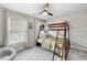 Bedroom featuring carpet, ceiling fan, a window with curtains, and a bunk bed at 112 Roseberry Way, Holly Springs, NC 27540