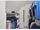 Walk-in closet with shelves and hanging rods containing an assortment of clothes and shoes at 112 Roseberry Way, Holly Springs, NC 27540