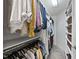 This well-organized walk-in closet with hanging rods and shelving offers ample storage for clothing and accessories at 112 Roseberry Way, Holly Springs, NC 27540
