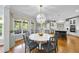 Bright dining area with a round table, stylish chairs, and a view of the deck and backyard at 112 Roseberry Way, Holly Springs, NC 27540