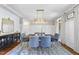 Inviting dining room with stylish chandelier, statement rug, and paneled walls at 112 Roseberry Way, Holly Springs, NC 27540