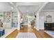 Elegant foyer with hardwood floors, white columns, built-in shelving, and view into the living room at 112 Roseberry Way, Holly Springs, NC 27540
