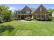 Beautiful brick home with manicured lawn and mature landscaping, offering classic curb appeal at 112 Roseberry Way, Holly Springs, NC 27540