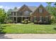 Charming brick house with a well-manicured front lawn and inviting curb appeal, perfect for families at 112 Roseberry Way, Holly Springs, NC 27540