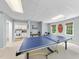 Recreational game room boasts a ping pong table, drum set, and access to the kitchen at 112 Roseberry Way, Holly Springs, NC 27540