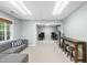 Entertainment area with a sectional couch, high-top table, and gaming stations at 112 Roseberry Way, Holly Springs, NC 27540